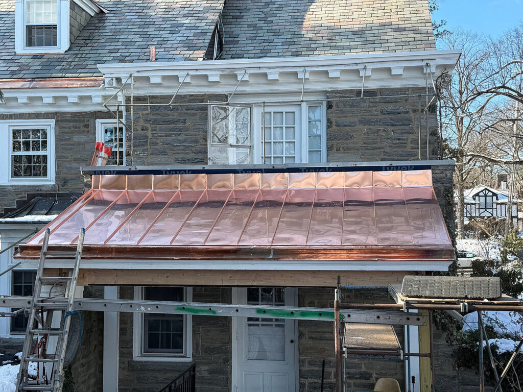 Traditional standing seam copper double locked roof installed.
